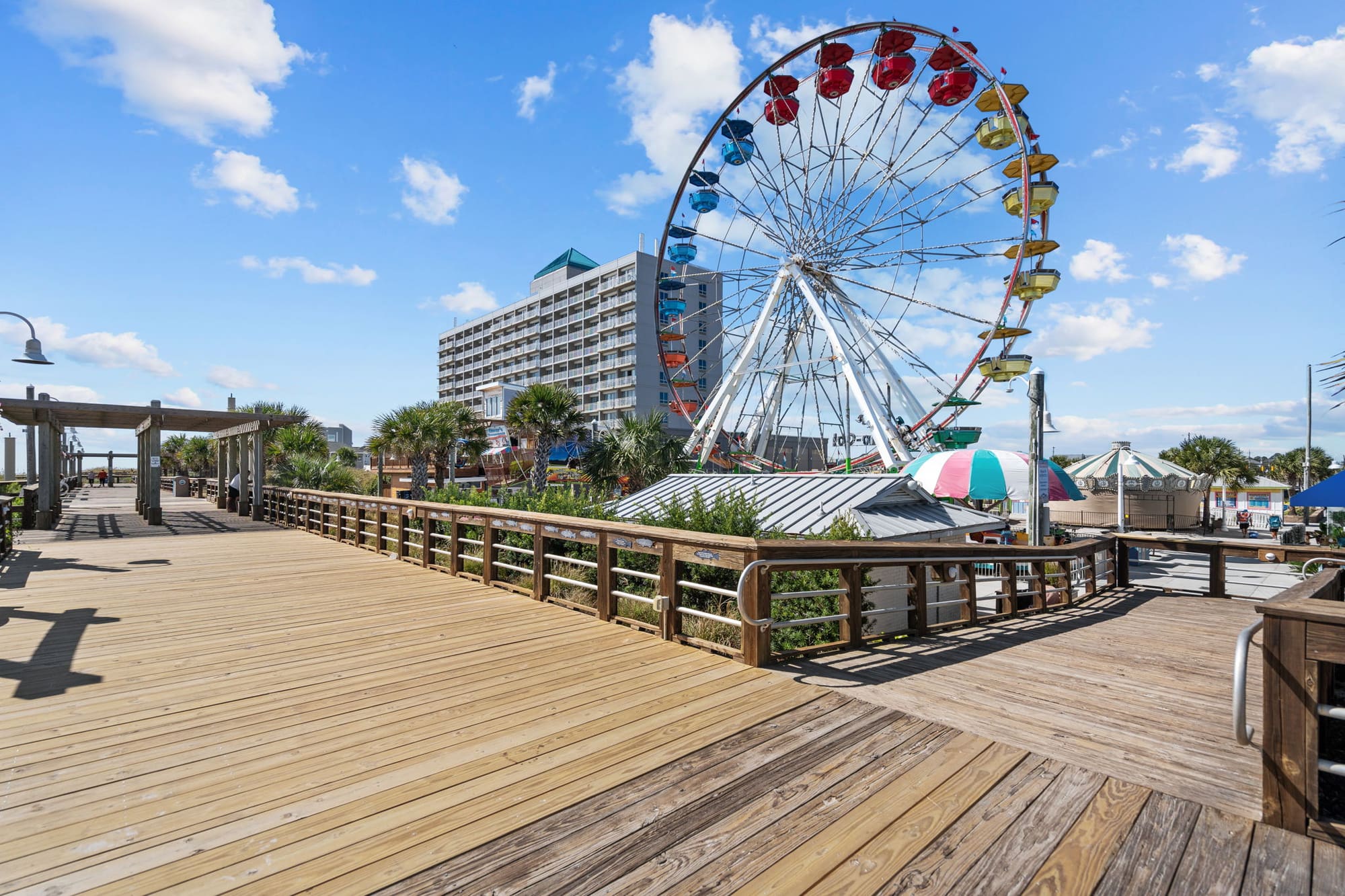 The Carolina Beach Boardwalk deck with the Ferris wheel in the distance