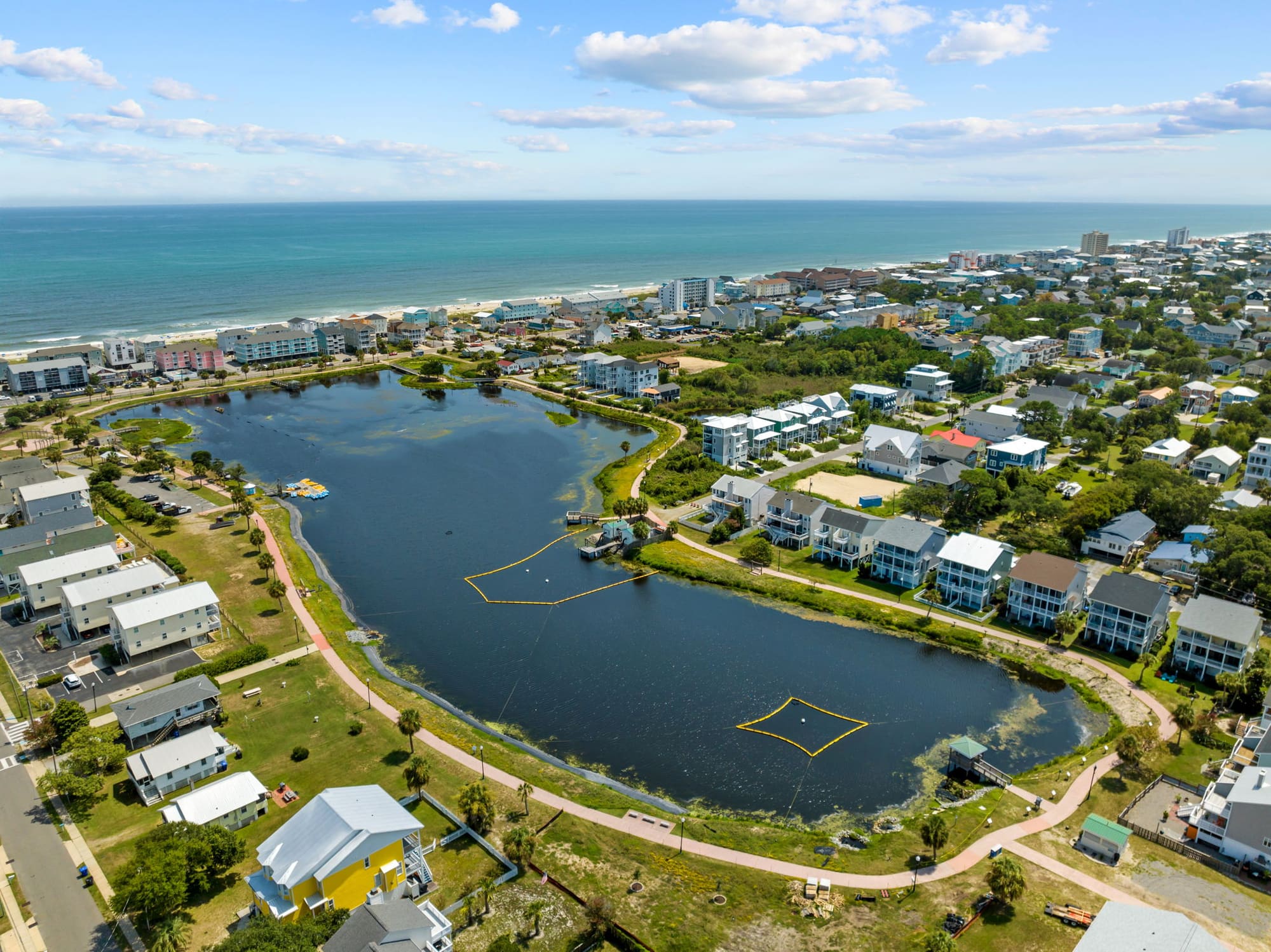 Homes around Carolina Beach Lake, with the ocean beyond