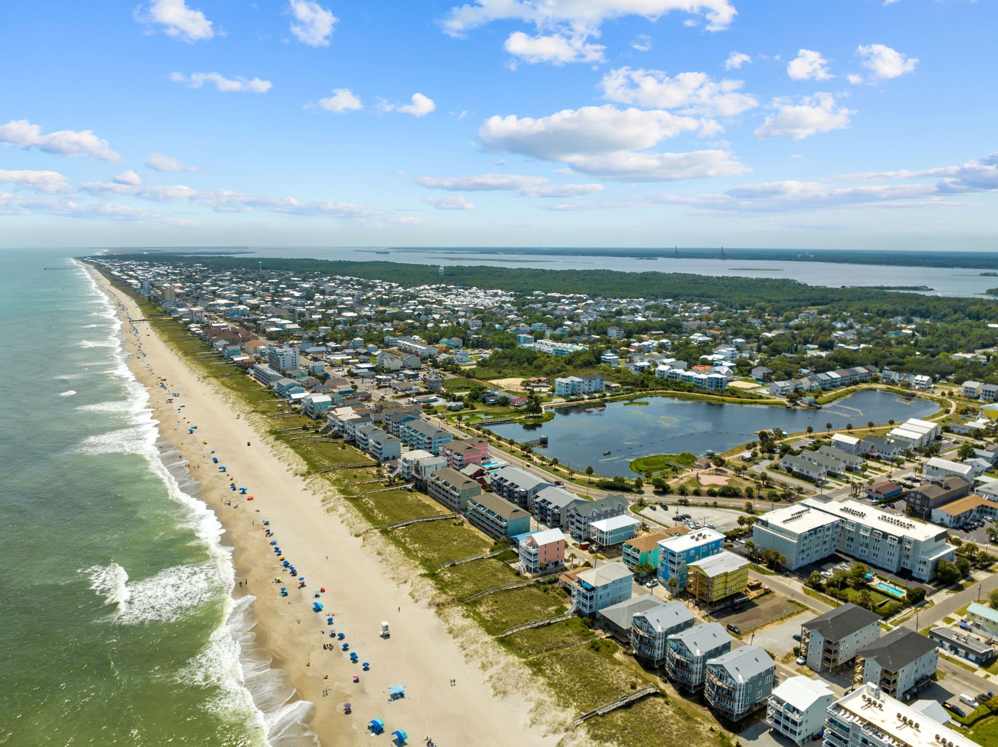 Aerial view of the long Carolina Beach strand and the beach homes behind it