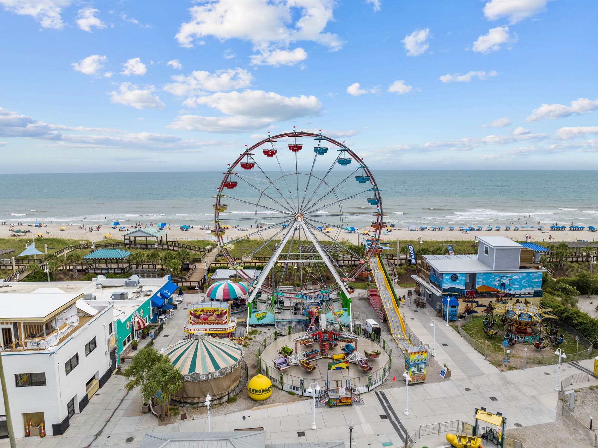 Aerial view of the Carolina Beach Boardwalk Ferris wheel by the ocean