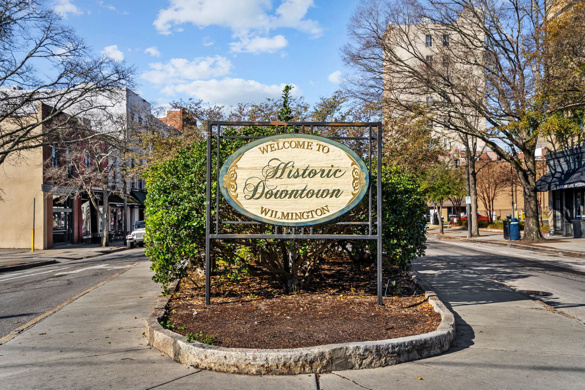 The Historic Downtown Wilmington sign at a brick intersection